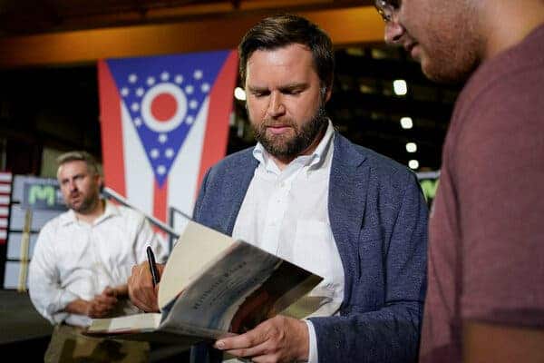 JD Vance signs a copy of his book, “Hillbilly Elegy” after a rally in 2021 announcing he was running for the U.S. Senate. 