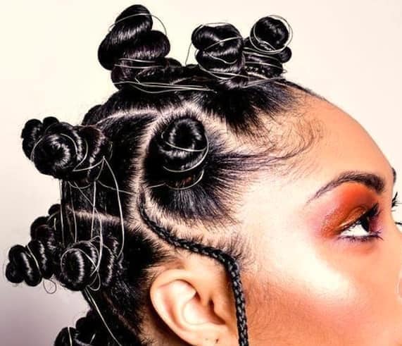 Bantu Knots with a Hanging Braid. Photo: @kemmystry Source: Instagram